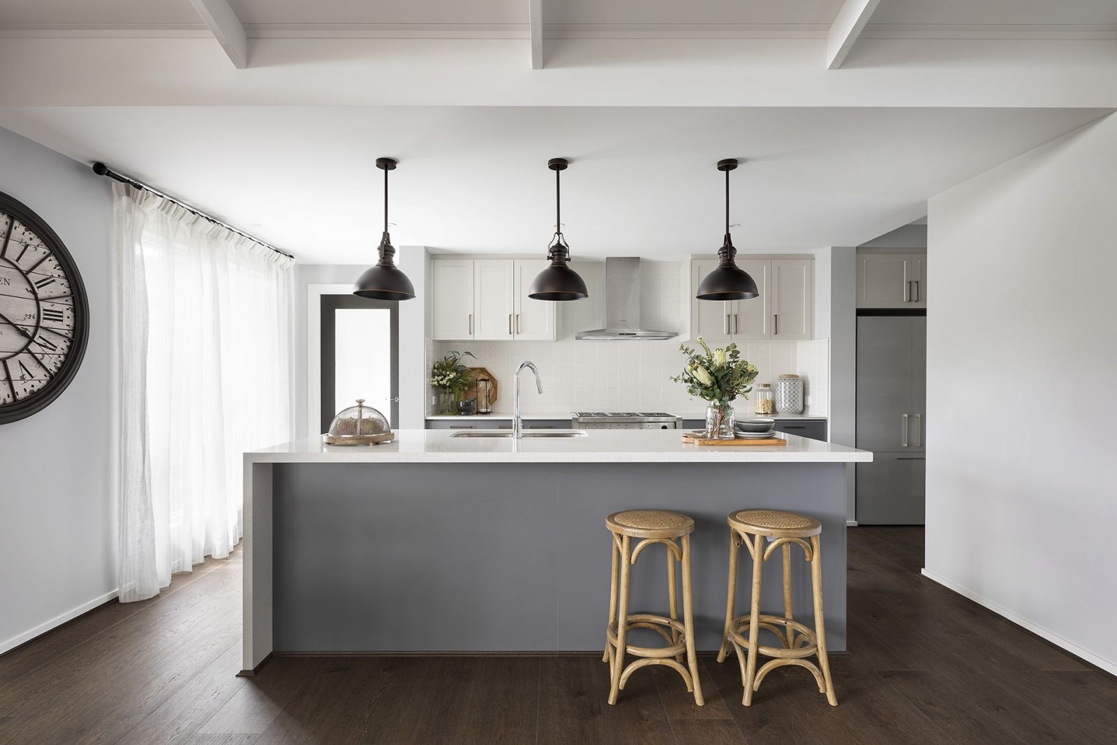 modern country style kitchen with black pendant lights shaker cabinets and grey doors